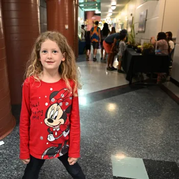 Aria Messer, 7, of Dixon, is exited to hold a stick insect at the Bohart Museum of Entomology petting zoo. (Photo by Kathy Keatley Garvey)
